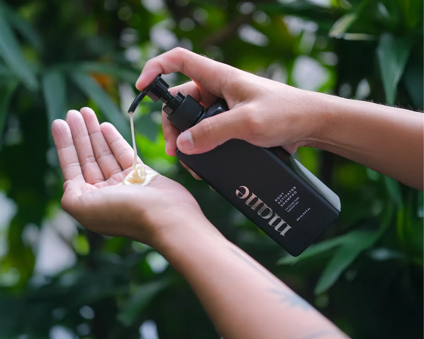 Mane Root Activator Shampoo being pumped into a hand